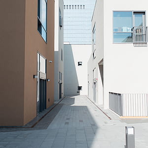 two white and brown buildings with glass windows at daytime thumbnail
