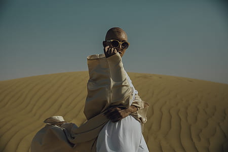 person wearing sunglasses standing at the dessert during set thumbnail