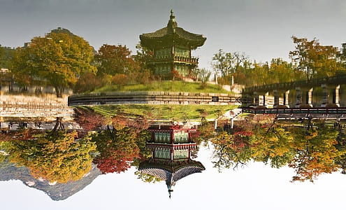 red and green temple near body of water thumbnail