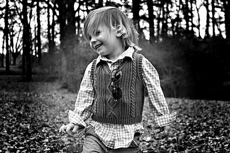 grayscale photography of child playing thumbnail