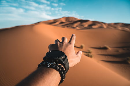 person reaching the desert during daytime thumbnail