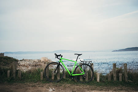 Green Bike By Water Photo thumbnail