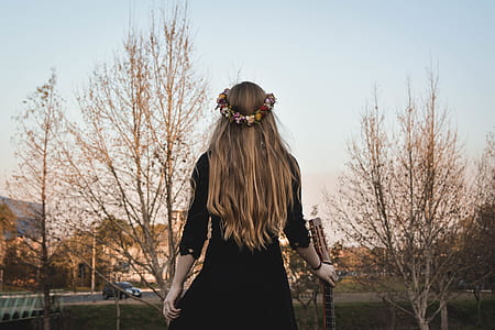 woman walking while holding guitar thumbnail