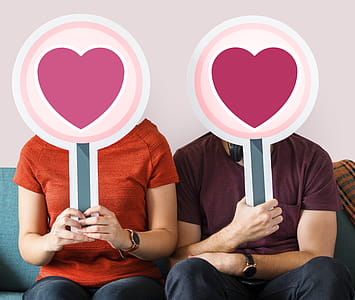 Man and Woman Holding Heart Boards thumbnail