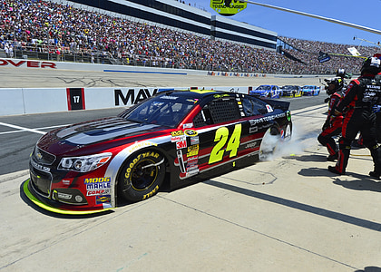 red and blue Chevrolet 24 stock car doing a pit stop thumbnail