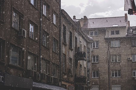 landscape photography of brown apartment during snow thumbnail