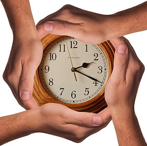 four hands holding analog clock displaying 2:20 thumbnail