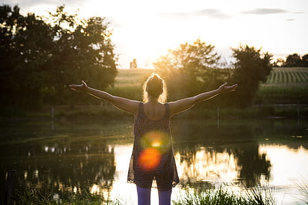 woman wearing black sleeveless top during sunset thumbnail