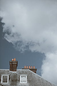 gray building under white and gray cloudy sky thumbnail