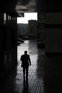 silhouette of man walking inside building thumbnail