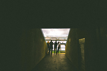four people on hallway during day time thumbnail