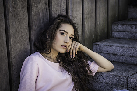 woman in pink shirt sitting on concrete stairs thumbnail