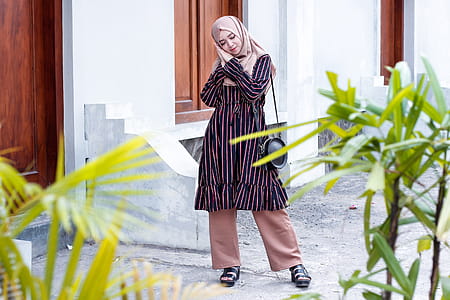 Woman Wearing Abaya Dress and Standing on Ground thumbnail