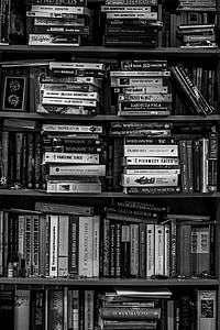 grayscale photo of piled books thumbnail