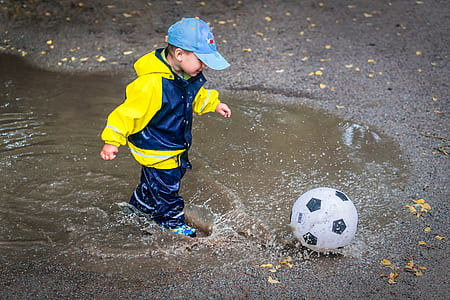 boy playing soccer ball during daytime thumbnail