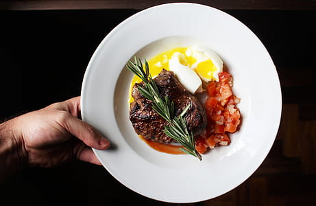 person holding plate with baked foods thumbnail