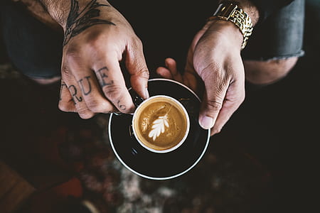 person holding teacup and saucer thumbnail