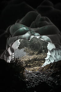 gray cave near trees thumbnail