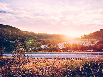 vehicle crossing road at golden hour thumbnail