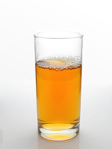 clear drinking glass filled with brown liquid thumbnail