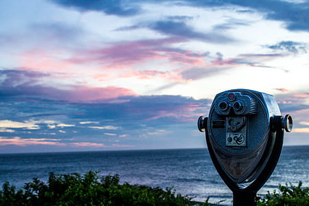 Gray and Black Tower Viewer Near Green Grass Field and Beach Under Blue White and Gray Clouds thumbnail