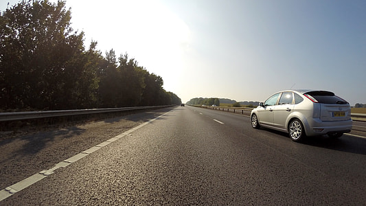 silver Ford Focus 5-door hatchback on asphalt road thumbnail