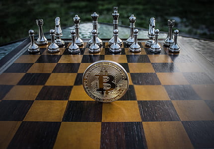 gold-colored coin on chessboard thumbnail