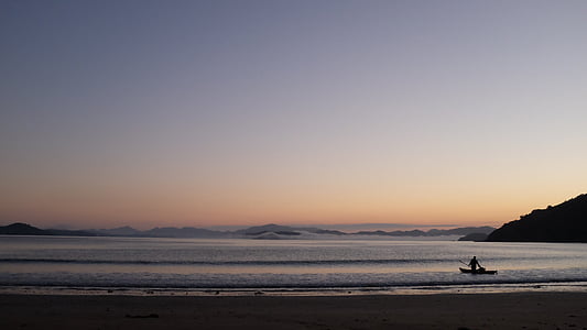 person on seashore during daytime thumbnail