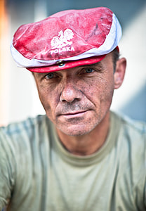 man wearing red and white Polska cap and brown shirt thumbnail