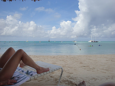 person lying on beach lounge on shore during daytime thumbnail
