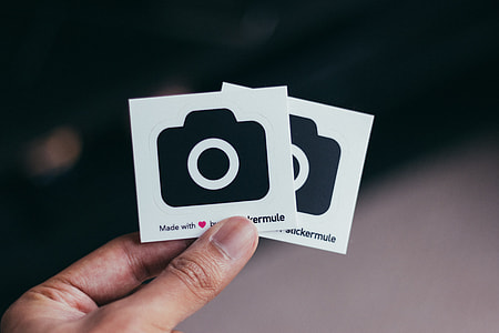 person holding two Instagram logo stickers thumbnail