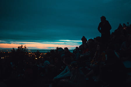 people sitting on cliff during dawn thumbnail