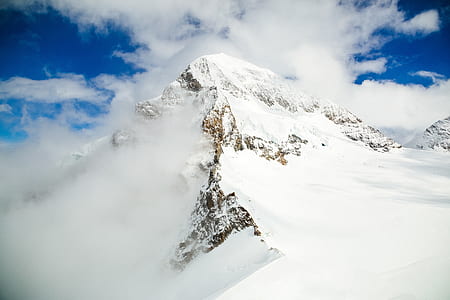 brown mountain covered with white snow during daytime thumbnail