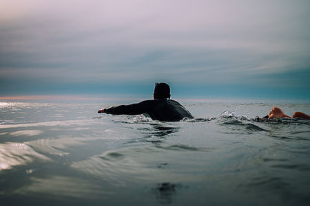 man swimming on water thumbnail
