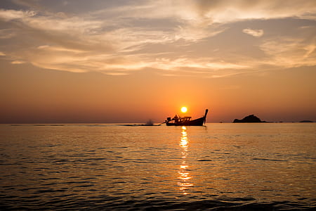 silhouette of boat on sea during golden hour thumbnail
