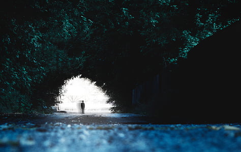 person standing near to white and black painted wall thumbnail