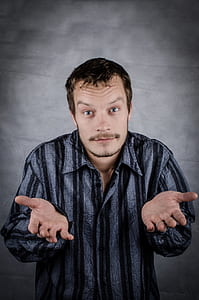 man wearing gray and black pinstripe collared long-sleeved top thumbnail
