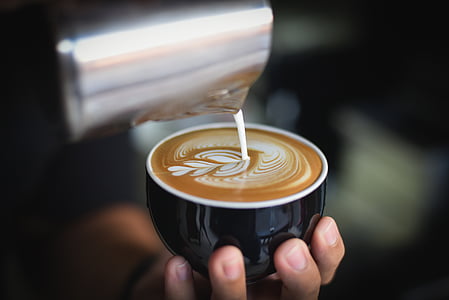 person holding black ceramic mug thumbnail