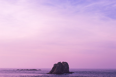 black stone formation in body of water thumbnail