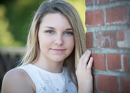 woman holding brick wall thumbnail