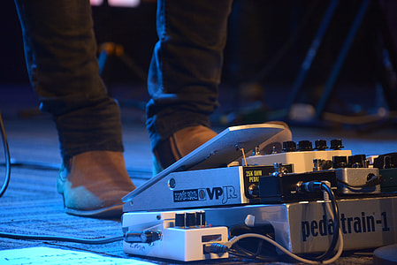 person standing in front of guitar amplifier thumbnail