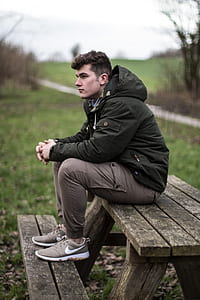 man seating on picnic table thumbnail