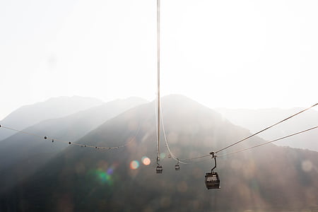 cable car near foggy mountain at day thumbnail