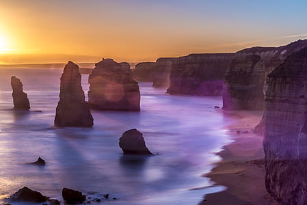 landscape photography of rock formation near the body of water thumbnail