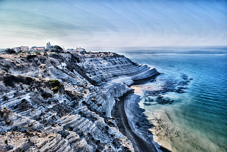 mountain near seashore aerial photography thumbnail