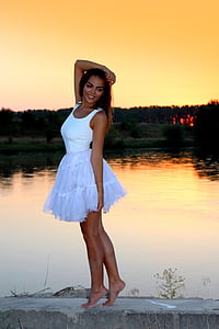 woman wearing white tank dress standing on deck thumbnail