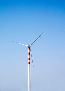 white windmill under white and blue sky at daytime thumbnail