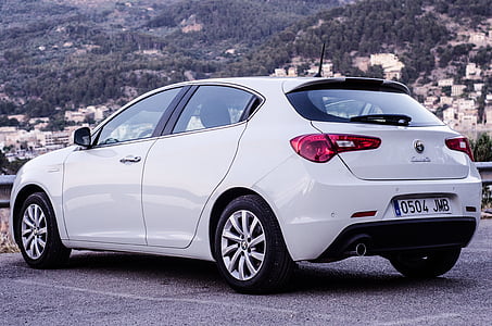 white 3-door hatchback on gray concrete floor thumbnail