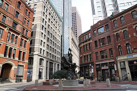 brown building in front of sculpture thumbnail