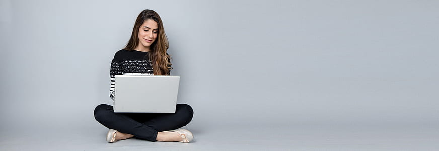 woman sitting in the floor while using white laptop thumbnail